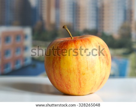 To buy an apartment. Apple on the background buildings. Favorable buying a home. Advertising real estate