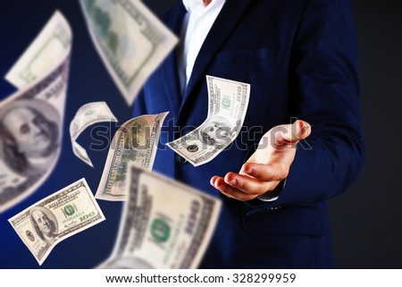 Businessman in suit with flying money