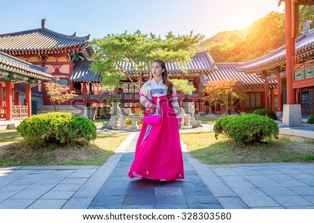 Woman with Hanbok in Gyeongbokgung,the traditional Korean dress. Royalty-Free Stock Photo #328303580