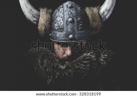 Danger, Viking warrior with iron sword and helmet with horns Royalty-Free Stock Photo #328318199