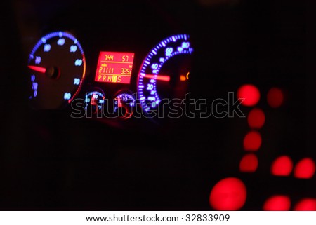 Car dashboard illuminated in the dark