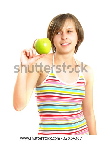 Portrait of a pretty Caucasian blond girl with a nice colorful striped dress who is smiling and she is holding a green apple in her hand. Isolated on white.