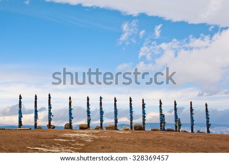 Wooden shaman totems. Shamanic poles with colored ribbons. Sacred poles with colored ribbons in island Olkhon.  Burhan Cape. Baikal Lake. Russian Federation