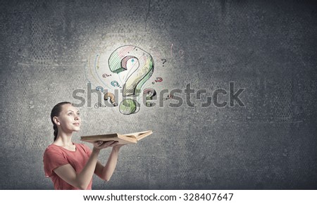 Young emotional woman in red dress with book in hands