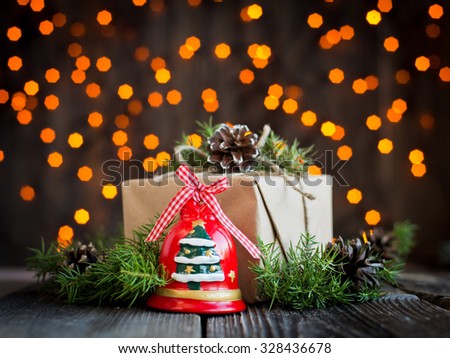 gift decorated with pine cones on the wooden background