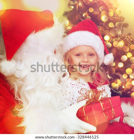 Santa giving a gift to little girl