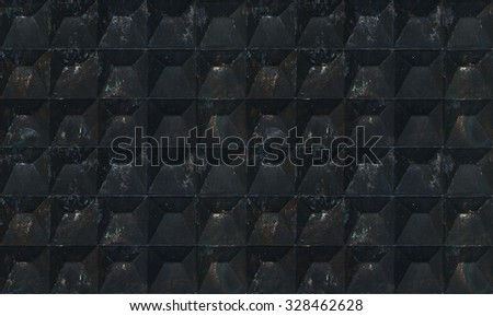 Background texture of aged dark deep concrete fence with square pattern. Tiled. Space black.
