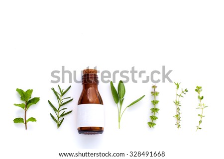 Bottle of essential oil with herb holy basil leaf, rosemary,oregano, sage,basil and mint on white background. Royalty-Free Stock Photo #328491668