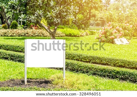 Blank billboard in green park field