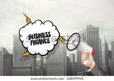 Business finance on speech bubble and businessman hand holding megaphone on cityscape background