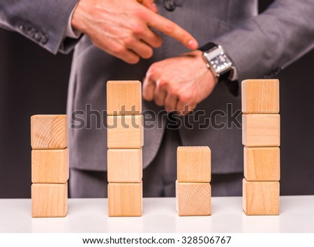 Creative idea. Young businessman presenting creative idea using wood cubes. Studio shooting isolated on Black background