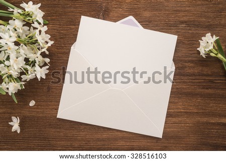 Flowers and envelope on wooden  background
