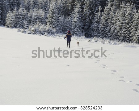 Girl playing with dog in the snow 