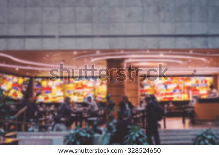De focused/Blurred image of a restaurant with customers. Vintage effect.