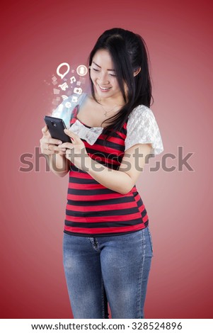 Photo of happy woman using mobile phone for internet browsing and access social media