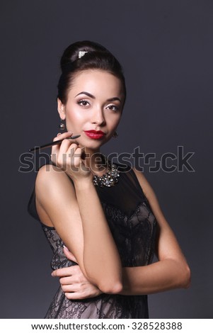 Retro woman portrait, standing on the black background 