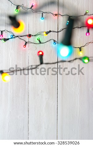christmas lights over white painted planks 