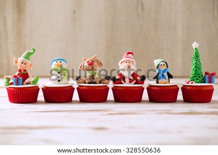 Group of christmas handmade cupcakes on wooden background
