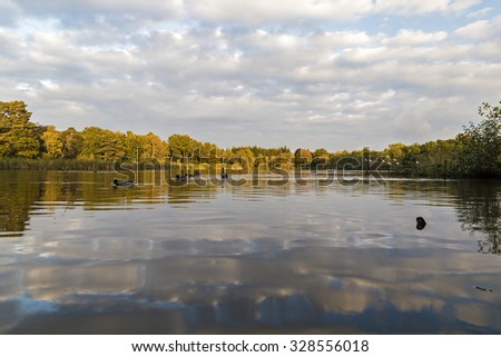 Showing a reflective scene at Stover lake in devon UK