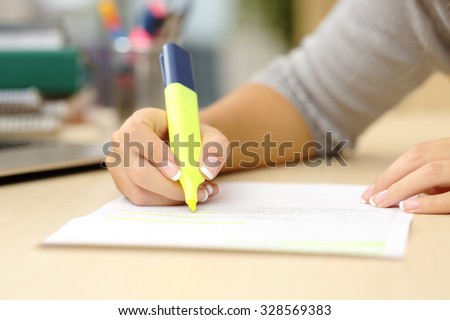 Close up of a student hand underlining a document on a desk at home Royalty-Free Stock Photo #328569383
