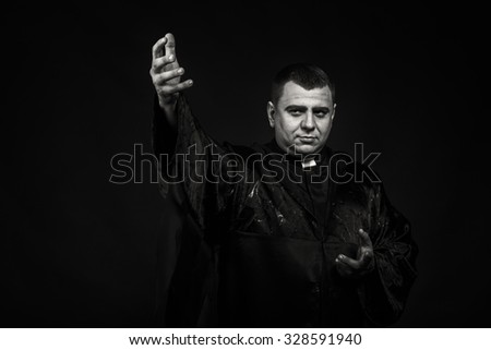 The professional game stage actor at the camera in the image of the priest. Theatrical productions. Professional makeup and costume designer. Photo for religious and cultural magazines and websites.