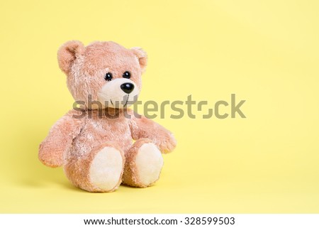 Teddy bear with yellow background