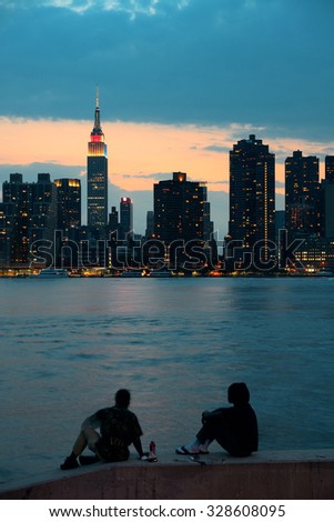 Tow men enjoy Manhattan view at night