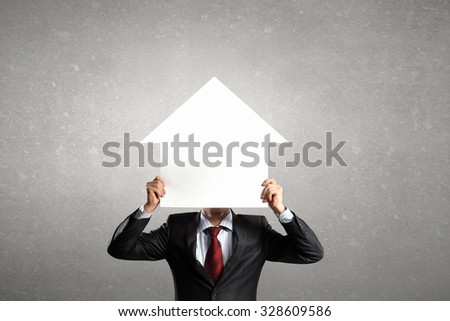 Unrecognizable businessman holding paper covering his face