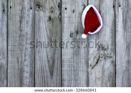 Santa Claus hat hanging on antique rustic wooden background