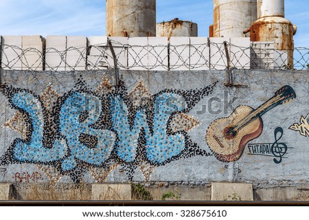 Beautiful street art of graffiti. Abstract color creative drawing fashion on the walls of the city. Urban contemporary culture. The writing on the walls. The protest culture

