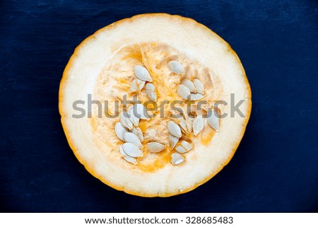 Fresh Pumpkin slice  on blue stone background.