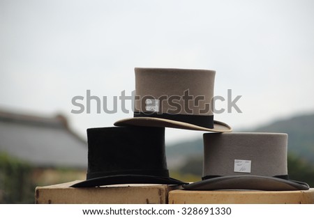 The picture of three vintage wool top hats in a flea market.
