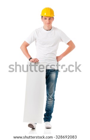 Smiling young businessman in hard hat showing blank placard board, isolated on white background