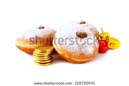 image of jewish holiday Hanukkah with donuts and wooden dreidels (spinning top). isolated on white 