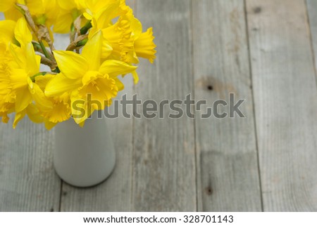 bouquet of daffodils on weathered wooden table