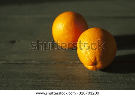 oranges with long sunset shades on garden table