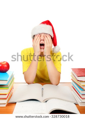 Bored Kid in Santa Hat on the School Desk Isolated on the White Background