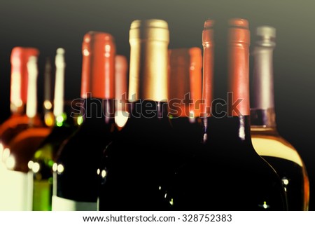wine bottles in two rows on black background