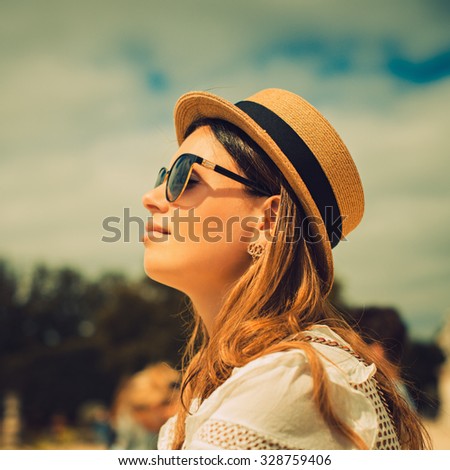 Beautiful joyful young woman enjoying her Paris travel. Fashion young blonde woman portrait. Photo with instagram style filters