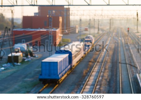 Blurred image of cargo train platform against sunrise