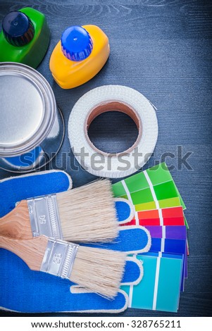 Paint containers color sampler protective gloves paintbrushes duct tape.