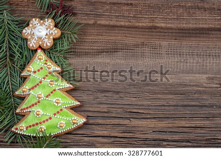 close-up of beautiful festive Christmas still life of the branches of spruce, cookies and spice on wood background with cracks studio