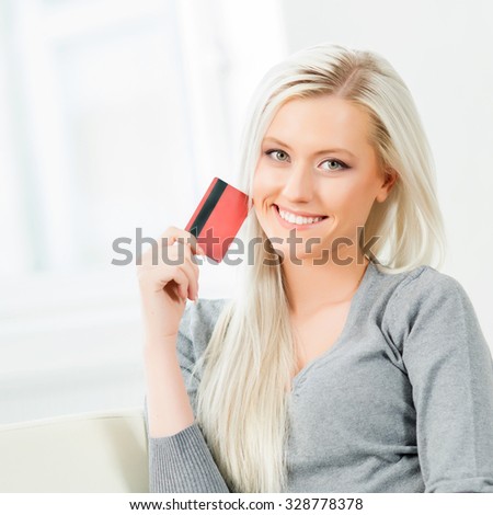 Young and happy woman with a credit card. Online shopping concept.