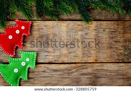 wood background with Christmas tree and homemade fleece toys. toning. selective focus