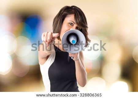 Pretty girl shouting with a megaphone
