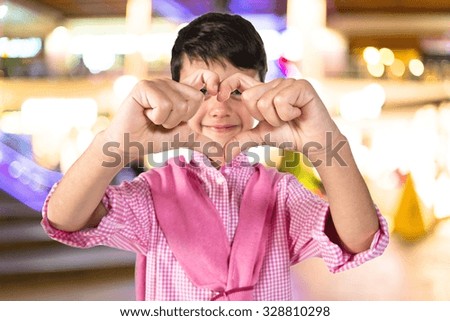 Boy making a heart with his hands 