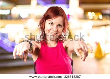 Young girl pointing on unfocused background