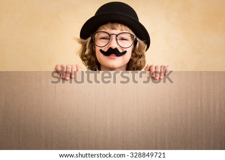 Funny kid with fake mustache holding banner blank Royalty-Free Stock Photo #328849721
