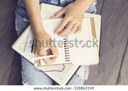 Girl with books and a diary  Royalty-Free Stock Photo #328863149