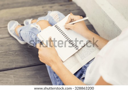 Girl making notes in the diary Royalty-Free Stock Photo #328863200
